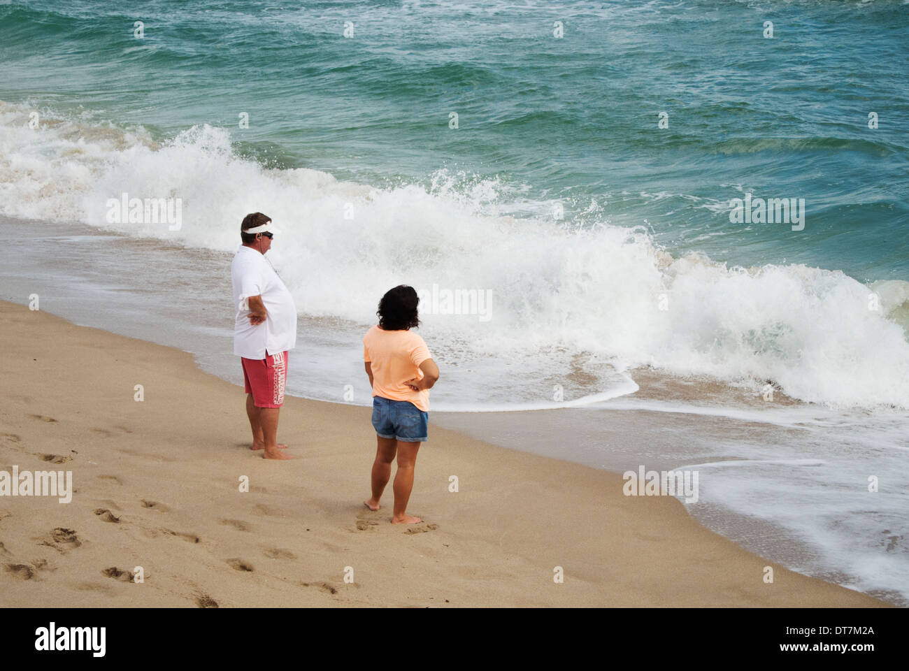 Couple standing watching hi-res stock photography and images - Alamy