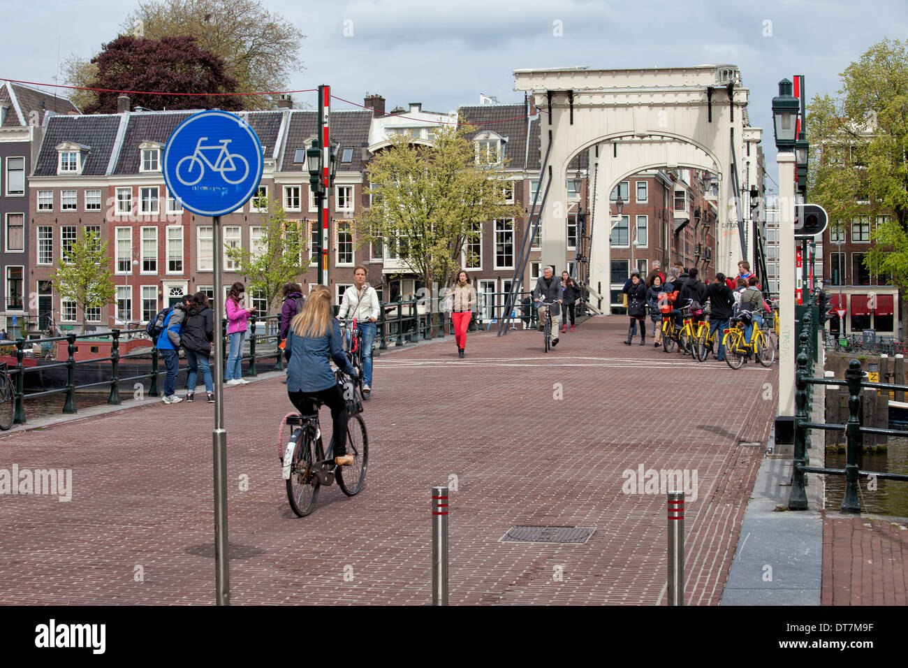 People on Skinny Bridge (Dutch: Magere Brug) over the Amstel river in Amsterdam, Holland, Netherlands Stock Photo