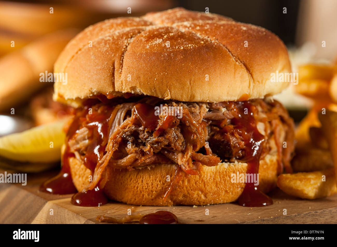 Barbeque Pulled Pork Sandwich with BBQ Sauce and Fries Stock Photo Alamy