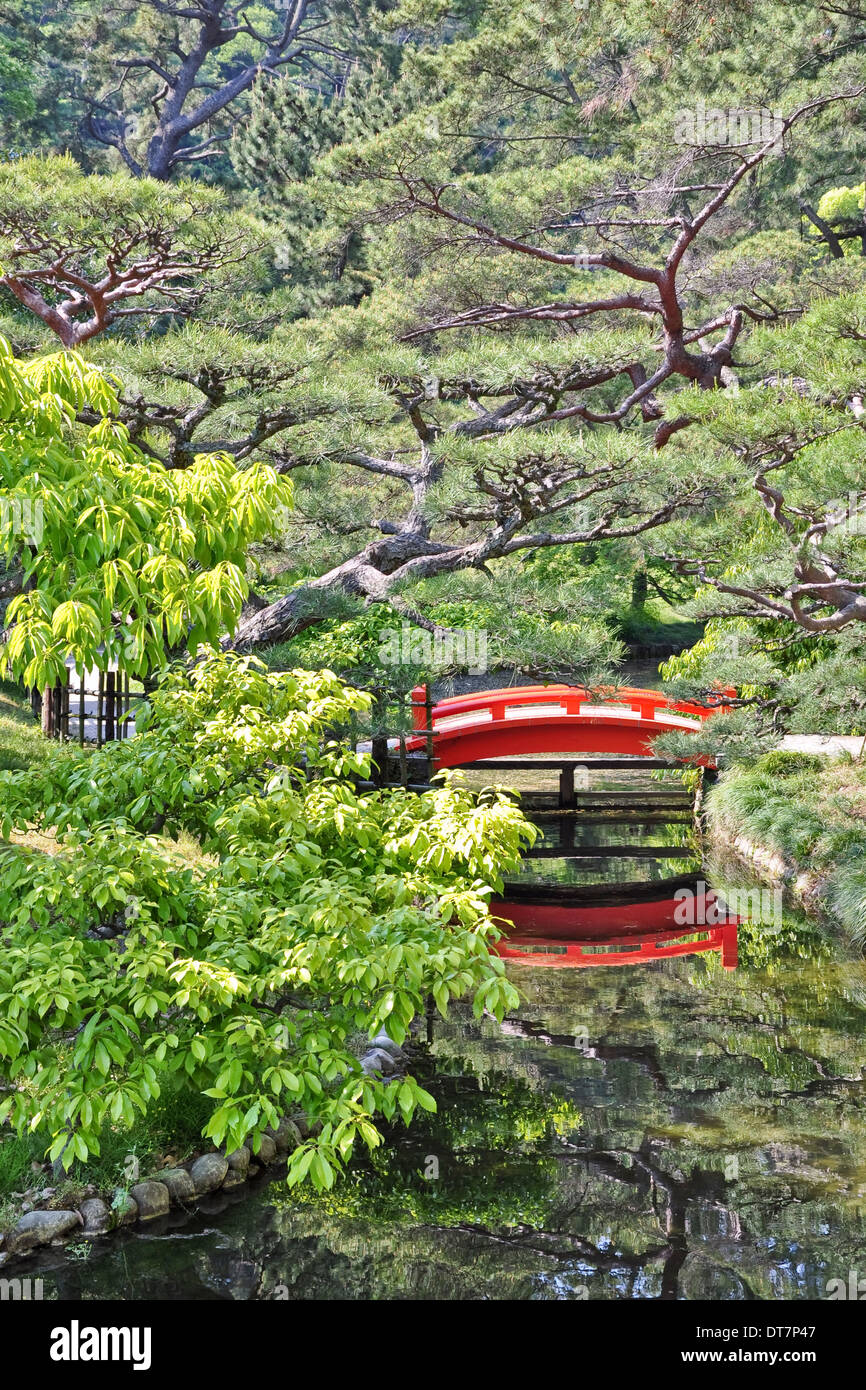 Orange traditional japanese bridge in a japanese garden - Ritsurin koen, Takamatsu, Chikoku, Japan Stock Photo
