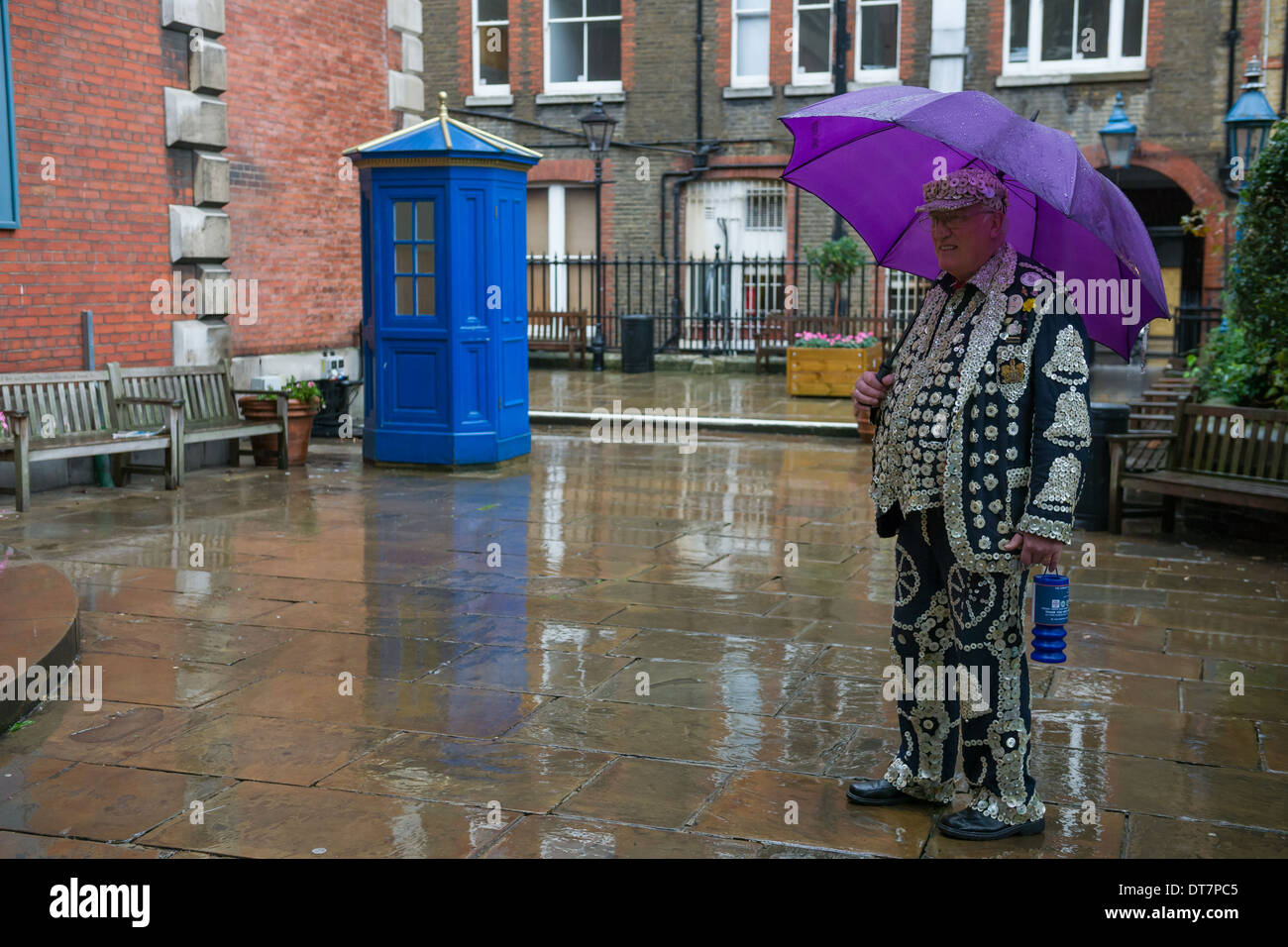 Pearly King with an umbrella arriving for the London Pearly Kings and Queens second Harvest Festival, St Paul's Church, Covent Garden, London, England Stock Photo