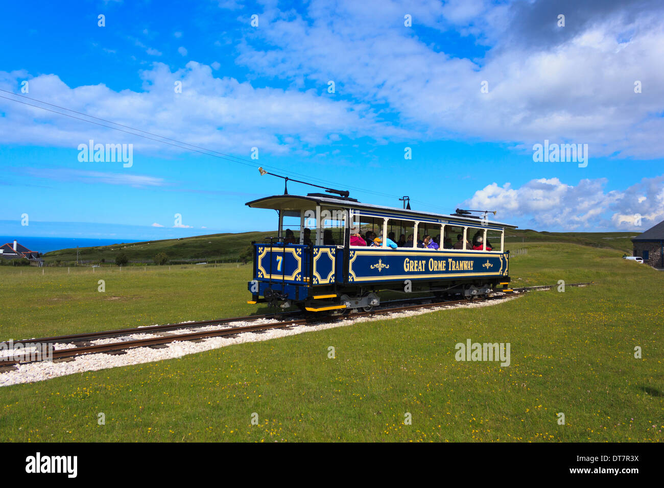 Tourists taking a ride on the Great Orme Tramway on top of the hill in the scenic seaside town of Llandudno, North Wales, UK. Stock Photo