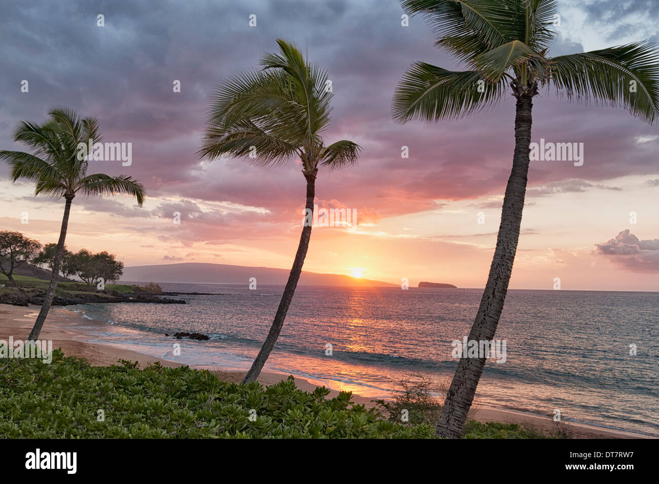 Makena Beach view of setting sun over the offshore islands of Kahoolawe and Molokini on Hawaii's island of Maui. Stock Photo