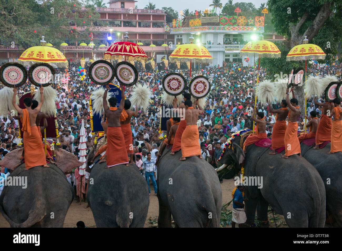 Priests waiving Aalavattom fans on elephant back at night in front of large crowds of pilgrims at the Goureeswara Temple Festival, Cherai, near Kochi (Cochin), Kerala, India Stock Photo
