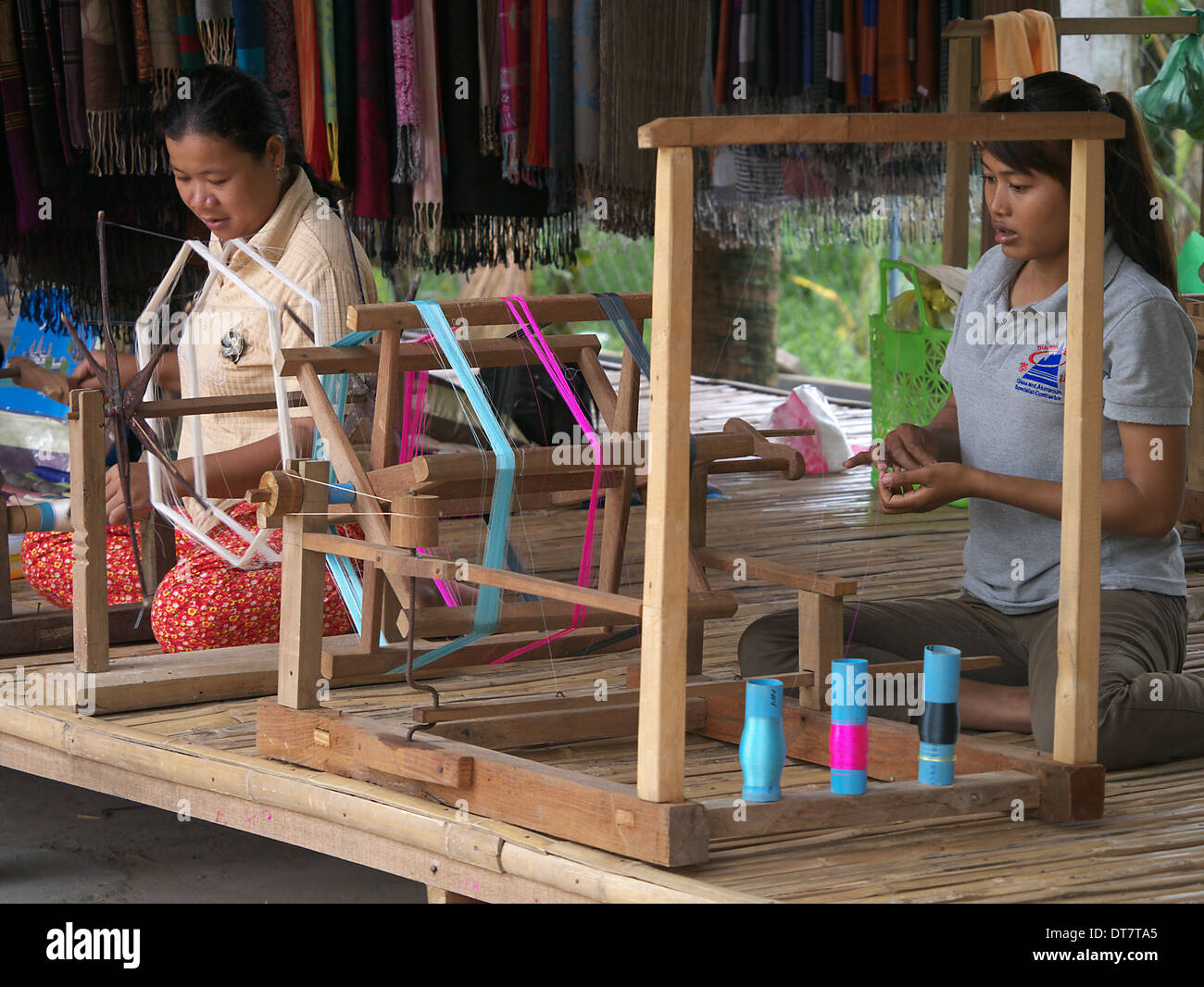 Two women spinning silk at Chong Koh silk village Cambodia Stock Photo