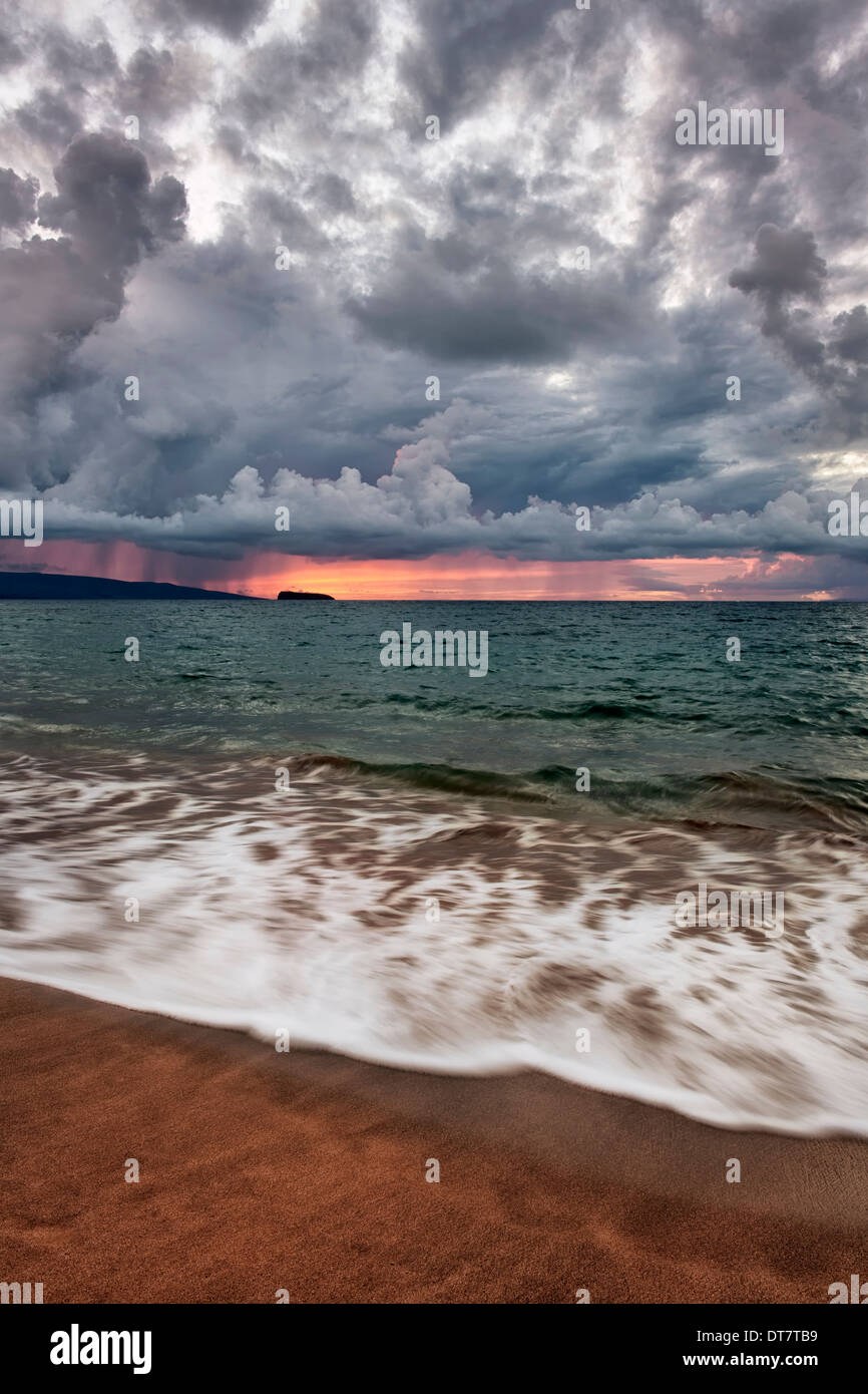 Passing showers over the silhouette islands of Kahoolawe and Molokini  from Makena Beach on Hawaii’s island of Maui. Stock Photo