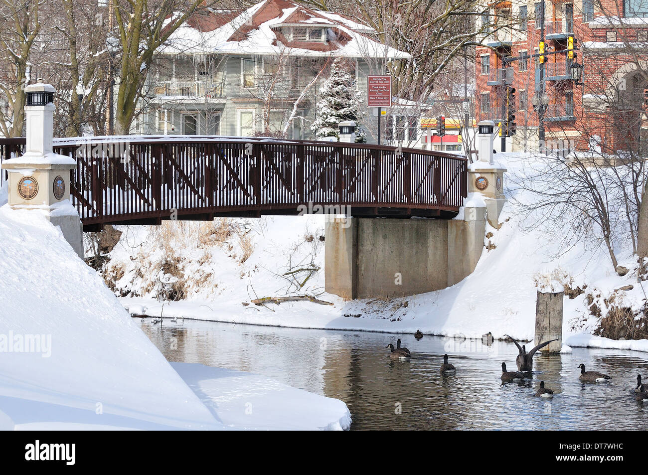 Park Bridge over stream in winter. Stock Photo