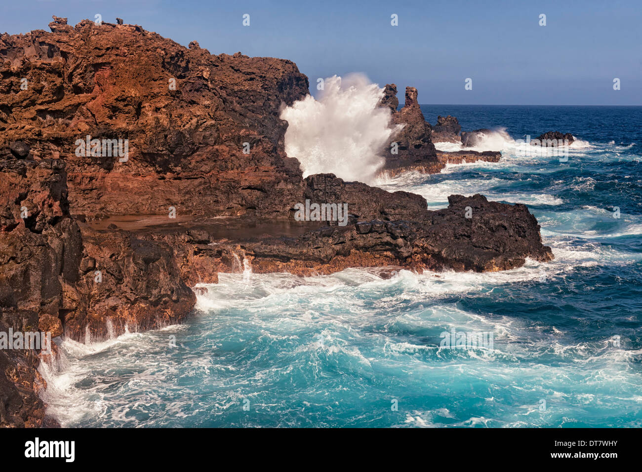 The Pacific Ocean crashes against the lava shoreline at Nakalele Point on Hawaii’s island of Maui. Stock Photo
