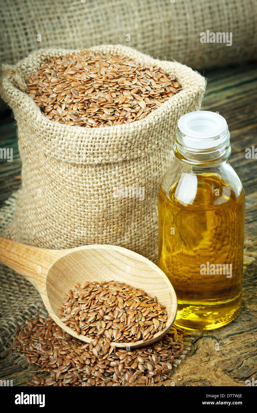 Linseed oil and flax seeds in small sack Stock Photo