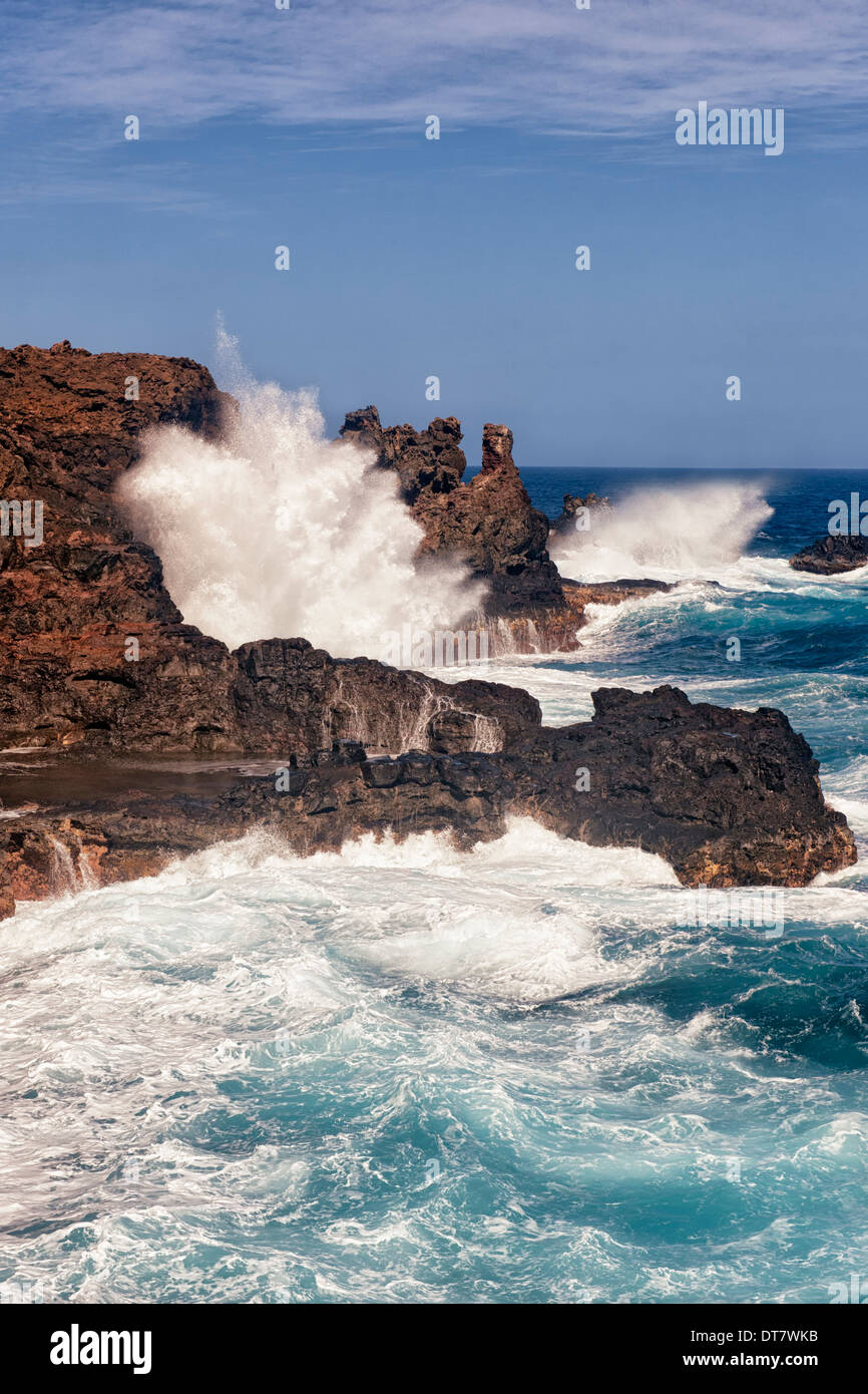 The Pacific Ocean crashes against the lava shoreline at Nakalele Point on Hawaii’s island of Maui. Stock Photo