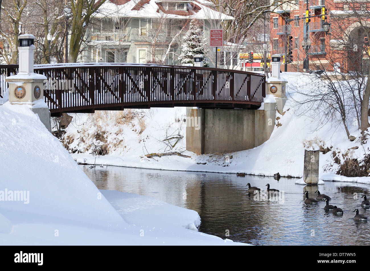 Park Bridge over stream in winter. Stock Photo