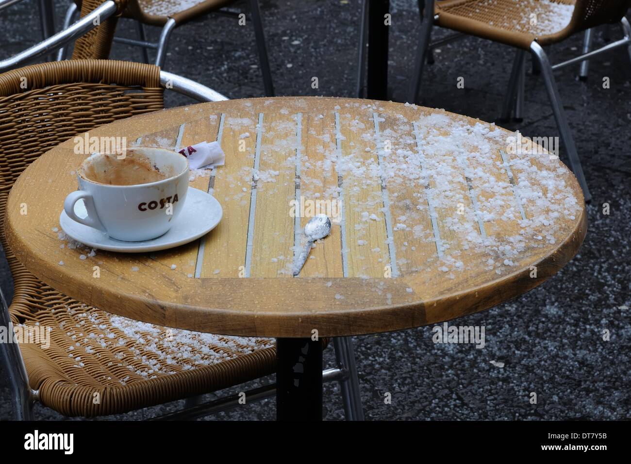 Sauchiehall Street, Glasgow, Scotland, UK.11th Feb, 2014. Glasgow suffers sudden wintery blast. Patrons of this outdoor Costa coffee cafe in Glasgow city centre dashed for cover when a sudden heavy hailstorm arrived this afternoon. Credit:  Douglas Carr/Alamy Live News Stock Photo