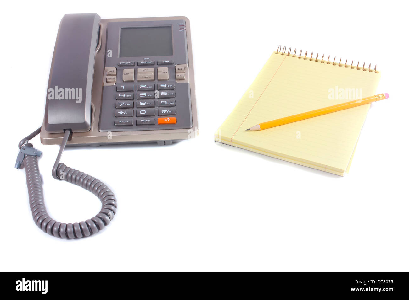 Phone and one spiral notebook with one pencil isolated over white background Stock Photo