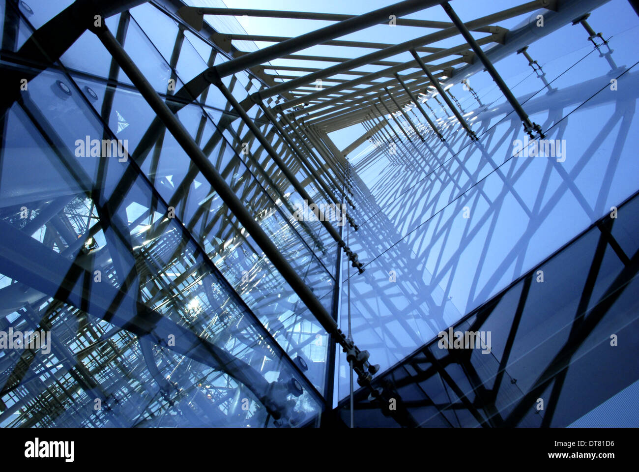 A bluecolored series of glass panels and supports along the side of a