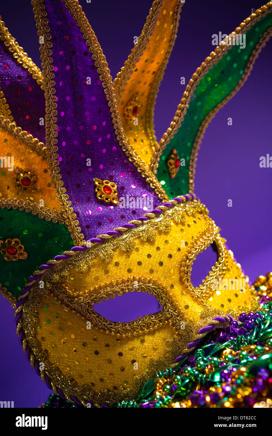Festive mardi gras, venetian or carnivale mask on a purple background Stock Photo