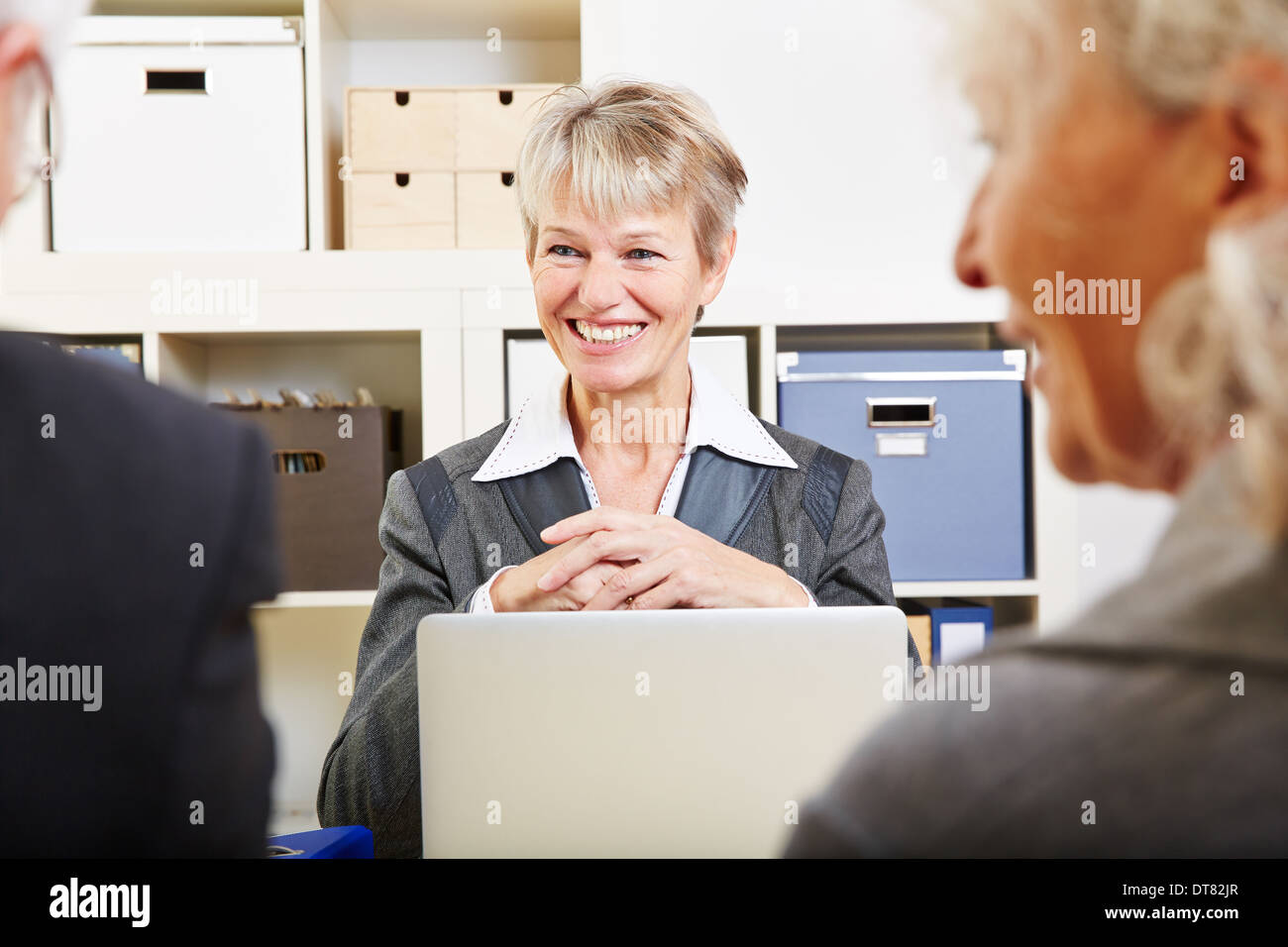 Senior couple getting financial advice from woman in a bank Stock Photo