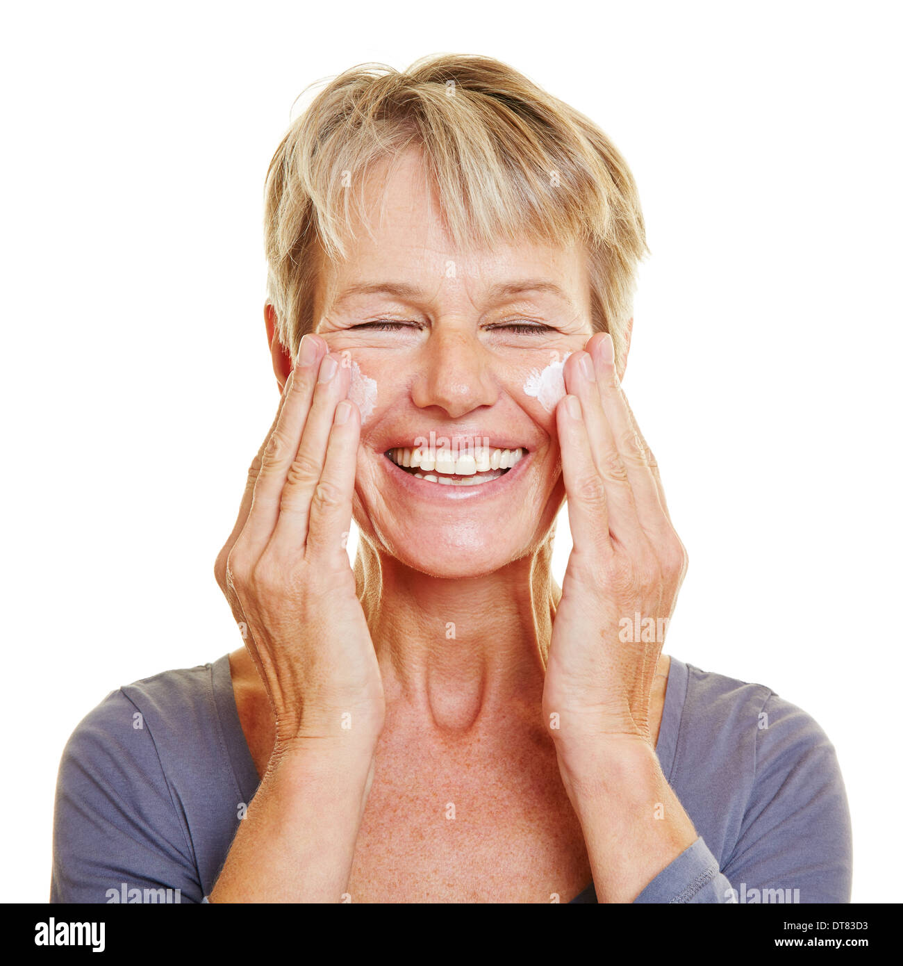 Elderly attractive woman caressing her skin with lotion Stock Photo