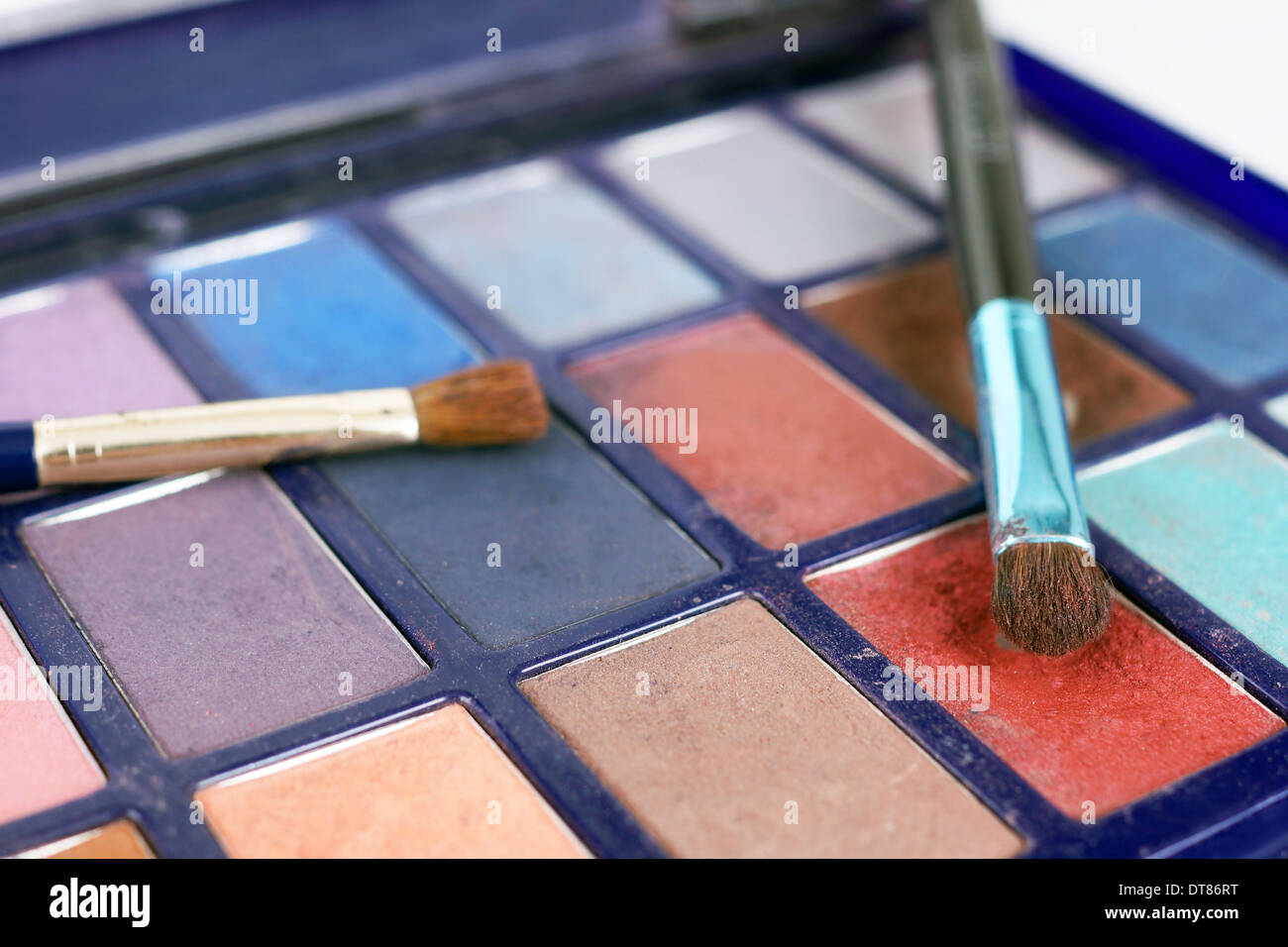 Macro of colorful eye shadow powders and brushes Stock Photo
