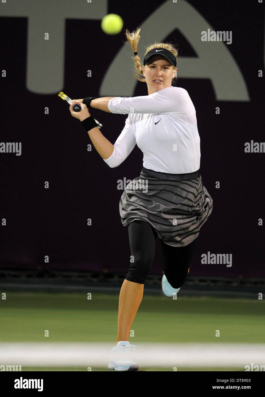Doha. 11th Feb, 2014. Eugenie Bouchard of Canada hits a return during her women's singles match against Bethanie Mattek-Sands of United States at the Qatar Open tennis tournament in Doha, Qatar on Feb. 11, 2014. Mattek-Sands won 2-0. Credit:  Chen Shaojin/Xinhua/Alamy Live News Stock Photo