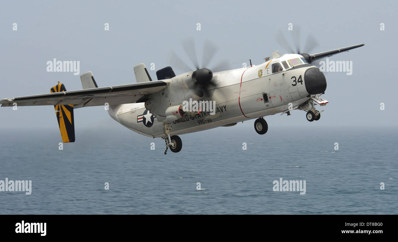 Gulf of Oman, August 24, 2013 - A C-2A Greyhound flies over the flight deck of the aircraft carrier USS Nimitz. Stock Photo