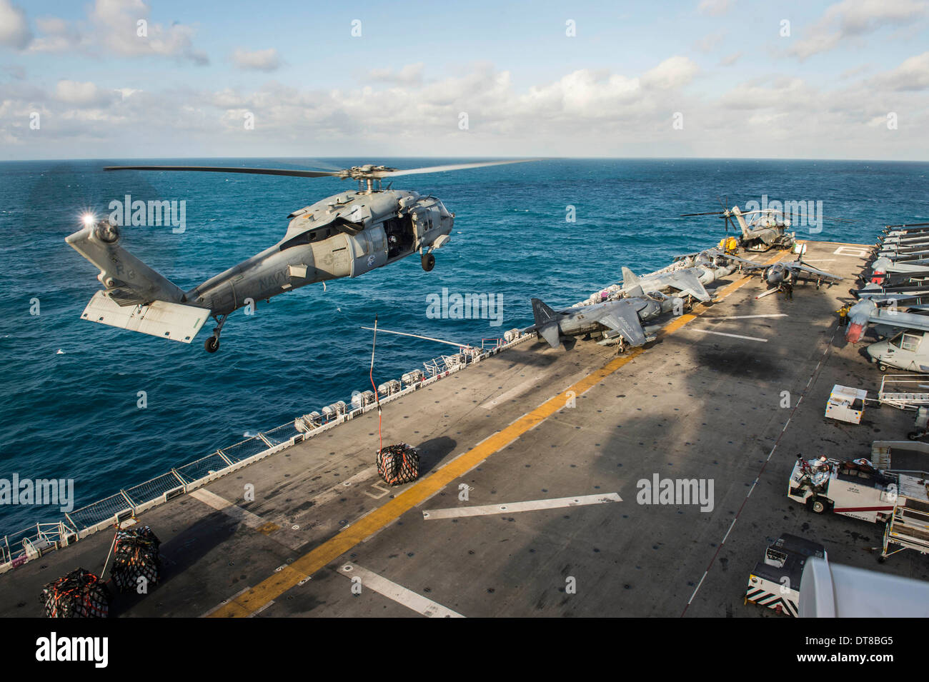 An MH-60S Sea Hawk helicopter delivers supplies to USS Bonhomme Richard. Stock Photo