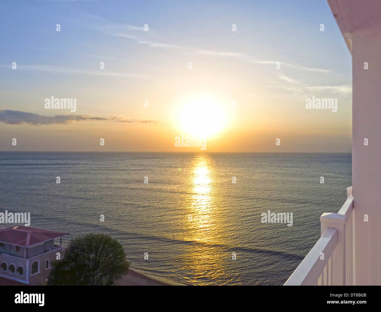 Beautiful sunrise seen from a hotel balcony looking into the ocean Stock Photo