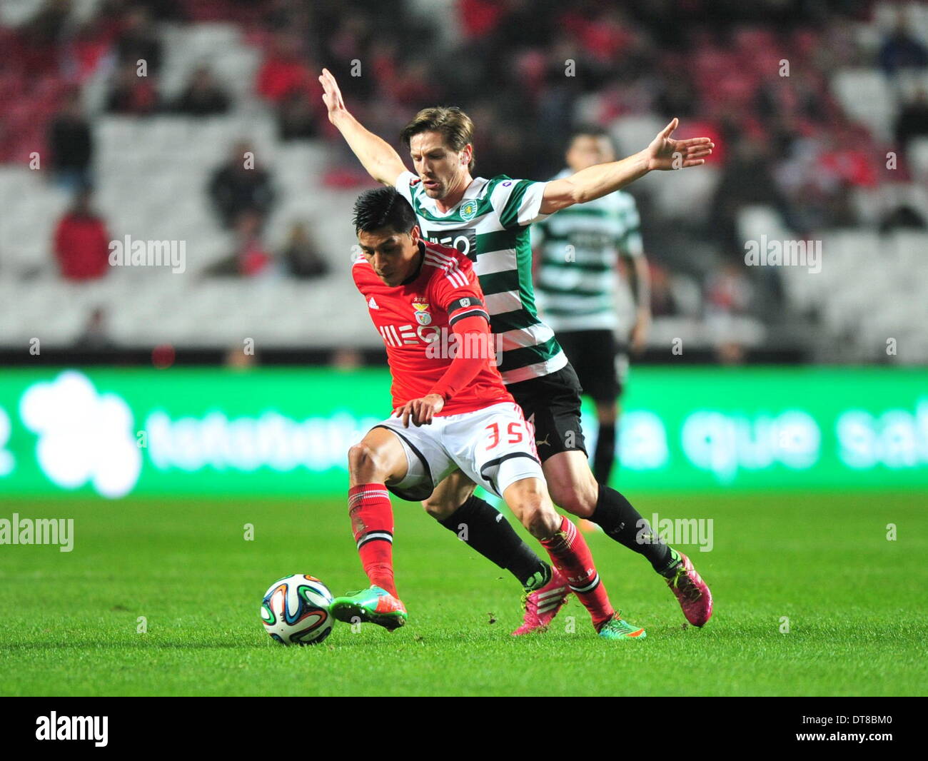 Lisbon. 11th Feb, 2014. Benfica's Enzo Perez (L) fights for the ball with Sporting's Adrien silva during their Portuguese Premier League soccer match at Luz stadium in Lisbon, Portugal on Feb. 11, 2014. Benfica won 2-0. © Zhang Liyun/Xinhua/Alamy Live News Stock Photo
