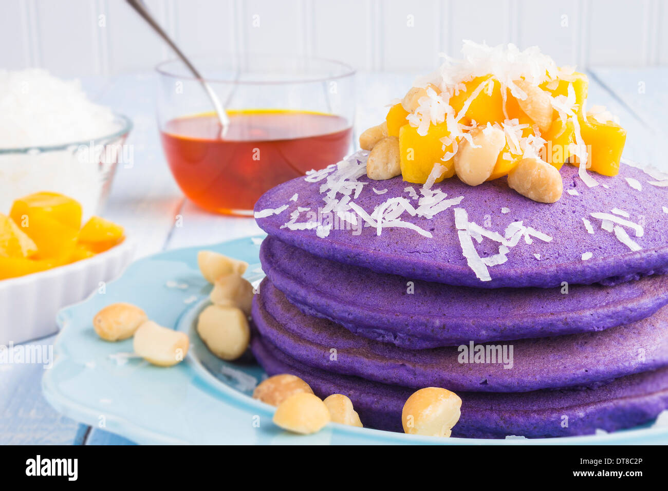 Taro pancakes topped with mango, macadamia nuts, shredded coconut and lilikoi syrup Stock Photo