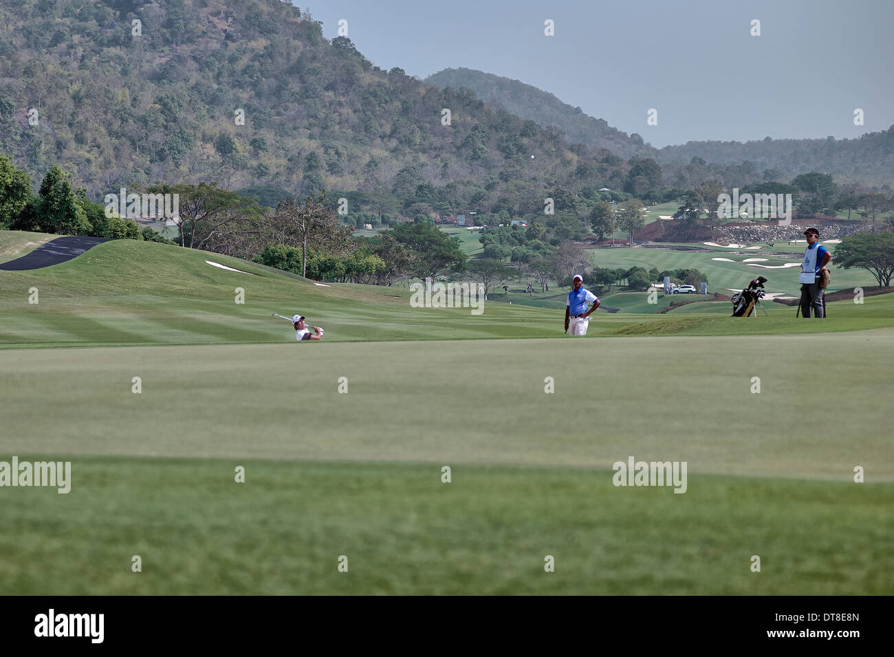Golf chip shot. Chipping out of a bunker into the green with watching