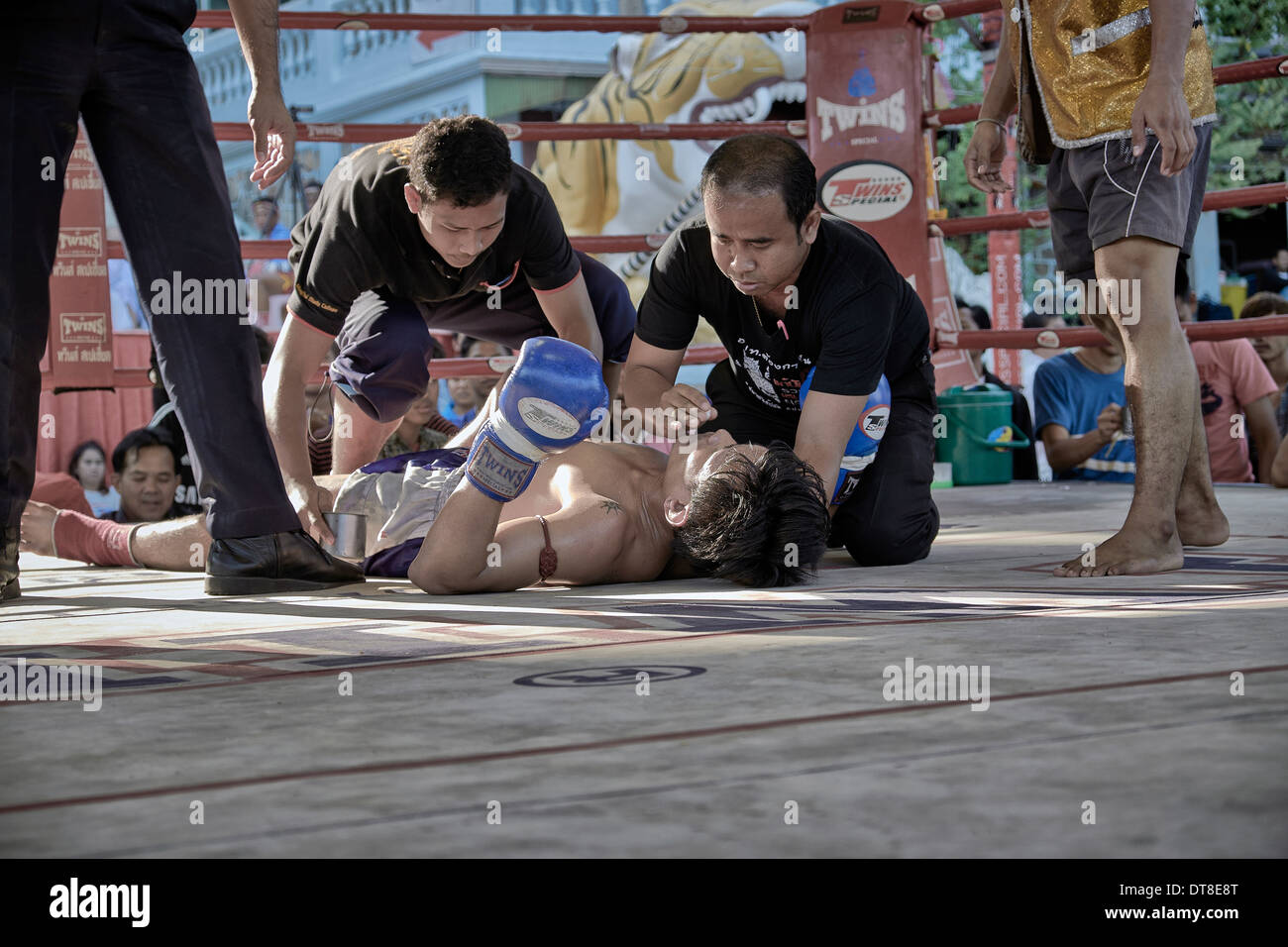 Muay Thai kick boxer receiving attention after a knock out blow. Thailand S. E. Asia. Stock Photo