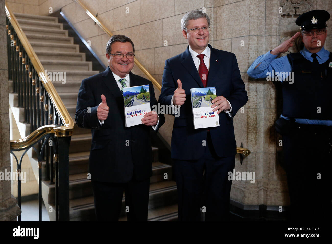 Ottawa, Canada. 11th Feb, 2014. Canada's Prime Minister Stephen Harper (C) and Finance Minister Jim Flaherty (L) announce the new federal budget at Parliament Hill in Ottawa, Canada, Feb. 11, 2014. Jim Flaherty on Tuesday unveiled a federal budget projecting a surplus in 2015. © David Kawai/Xinhua/Alamy Live News Stock Photo