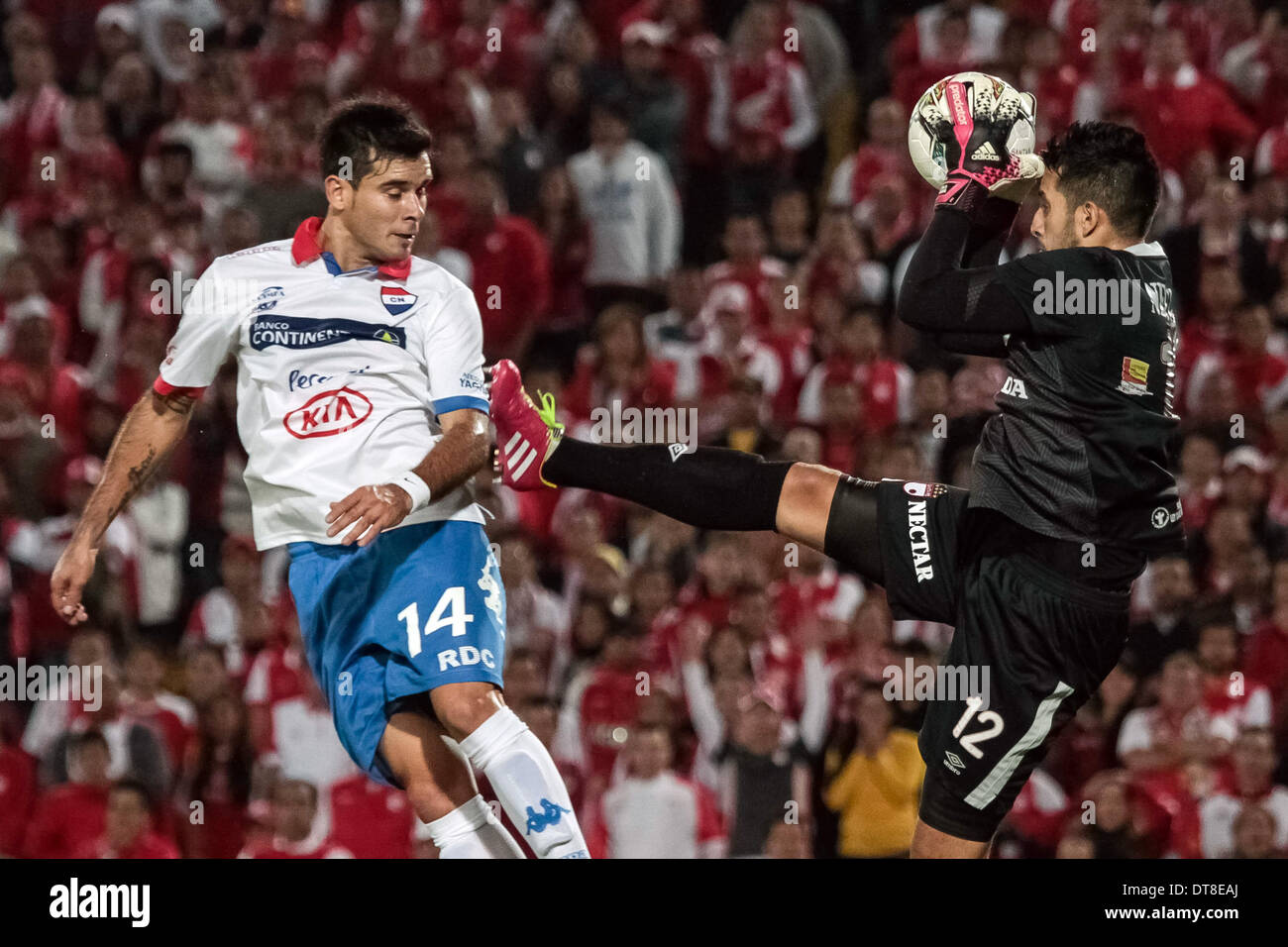 Bogota, Colombia. 11th Feb, 2014. Goalkeeper Camilo Vargas (R) of Colombia's Santa Fe vies for the ball with Marcos Megarejo of Paraguay's Nacional during their Copa Libertadores soccer match at El Campin Stadium, in Bogota City, capital of Colombia, on Feb. 11, 2014. © Jhon Paz/Xinhua/Alamy Live News Stock Photo