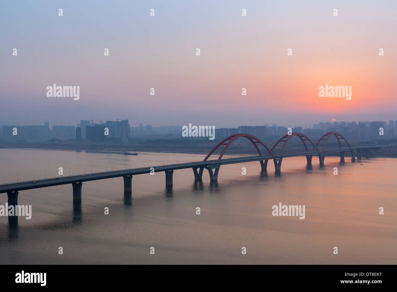 Sunset at Fu'yuan bridge, Chang'Sha, Hu'nan, China. Pollution blurred the sky, but the sun still tried its best to shine. Stock Photo