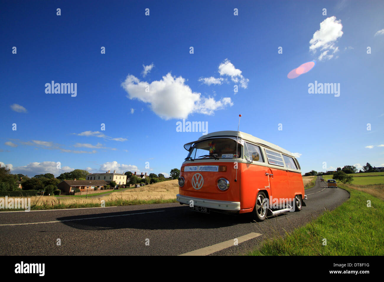 Volkswagen campervan driving along road Stock Photo Alamy