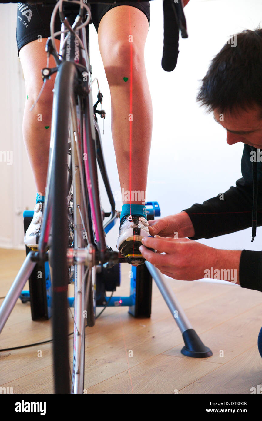 young female rider on racing bike and turbo attends a professional bike ...
