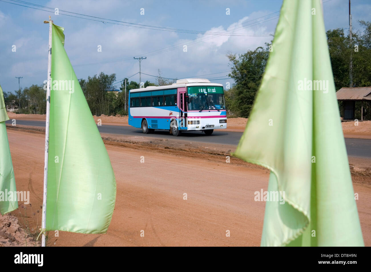 A bus is passing green flags which mark new road construction in