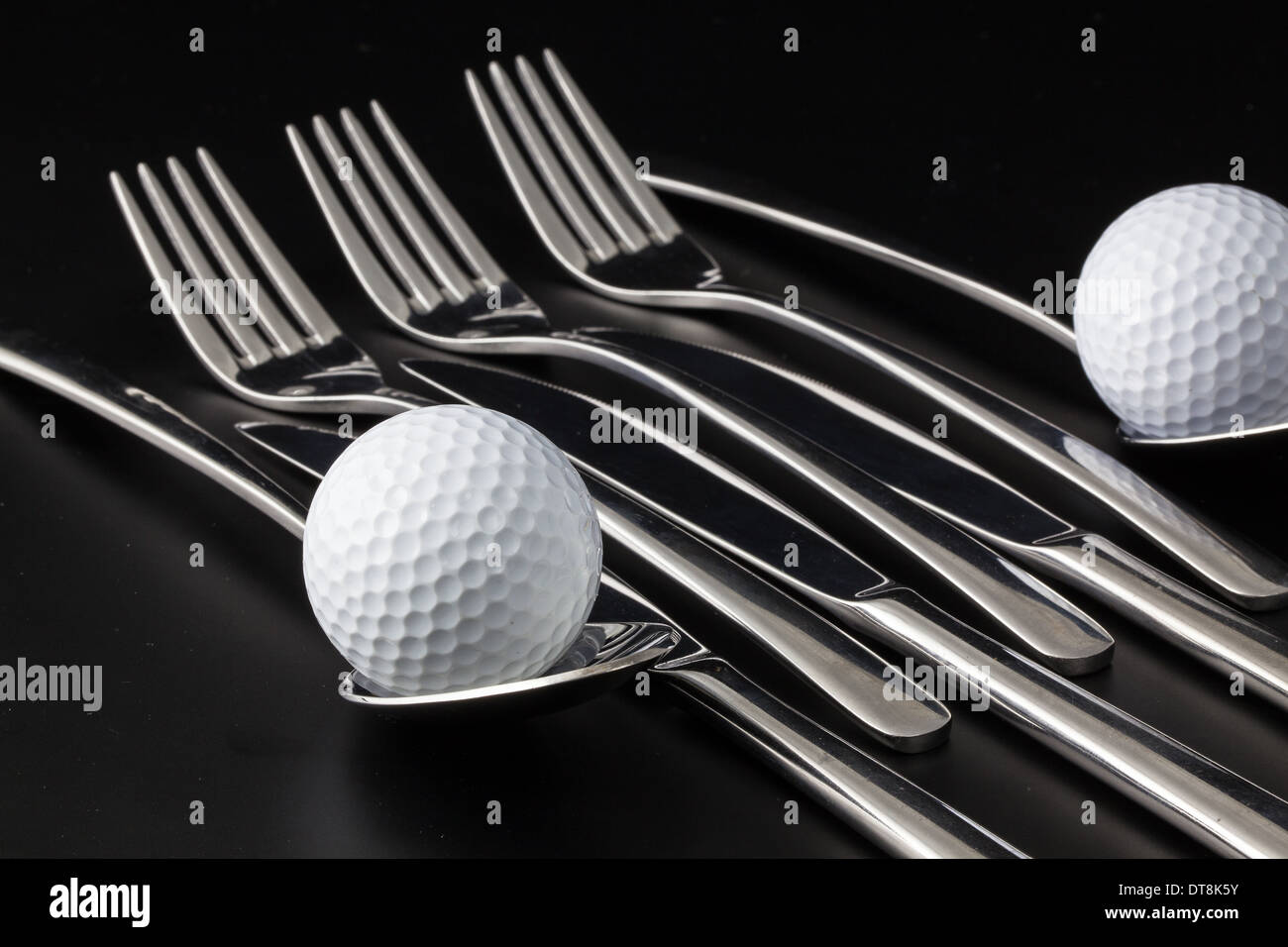 Forks,spoons and knife on a black table Stock Photo
