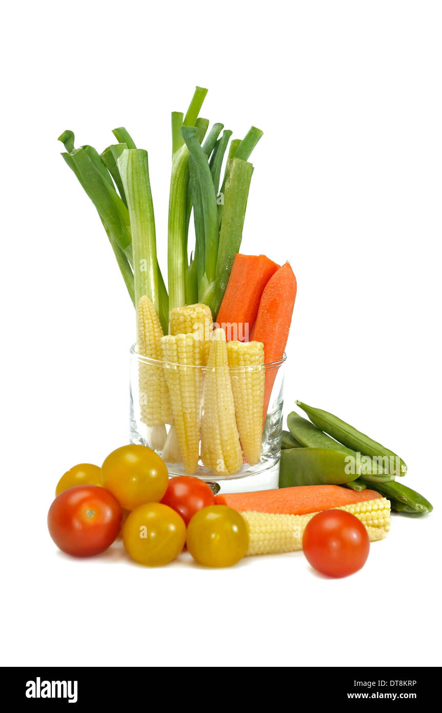 different raw vegetables arranged in a glass on white background Stock