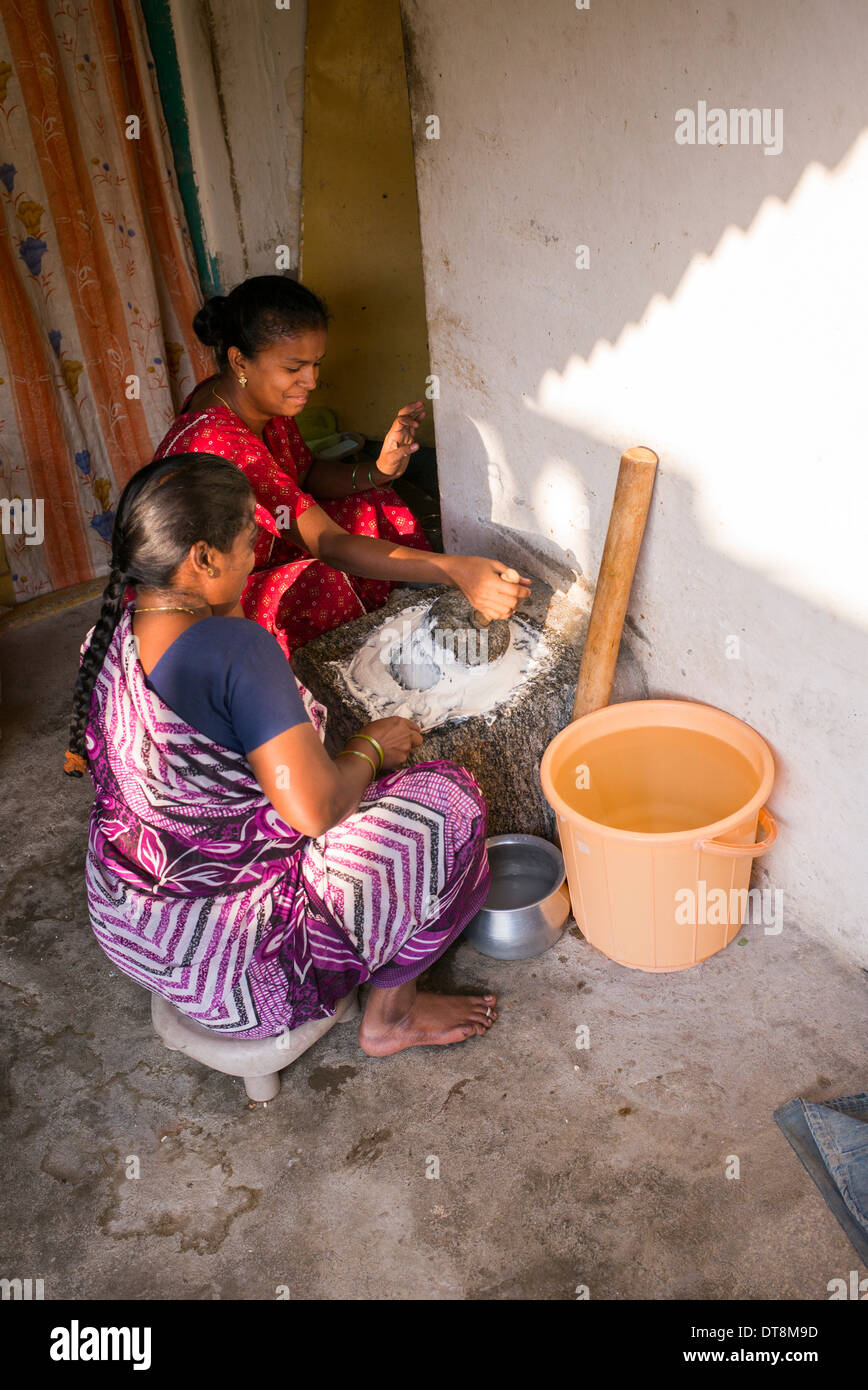 Indian women making dosa batter outside their town house. Andhra Pradesh, India Stock Photo