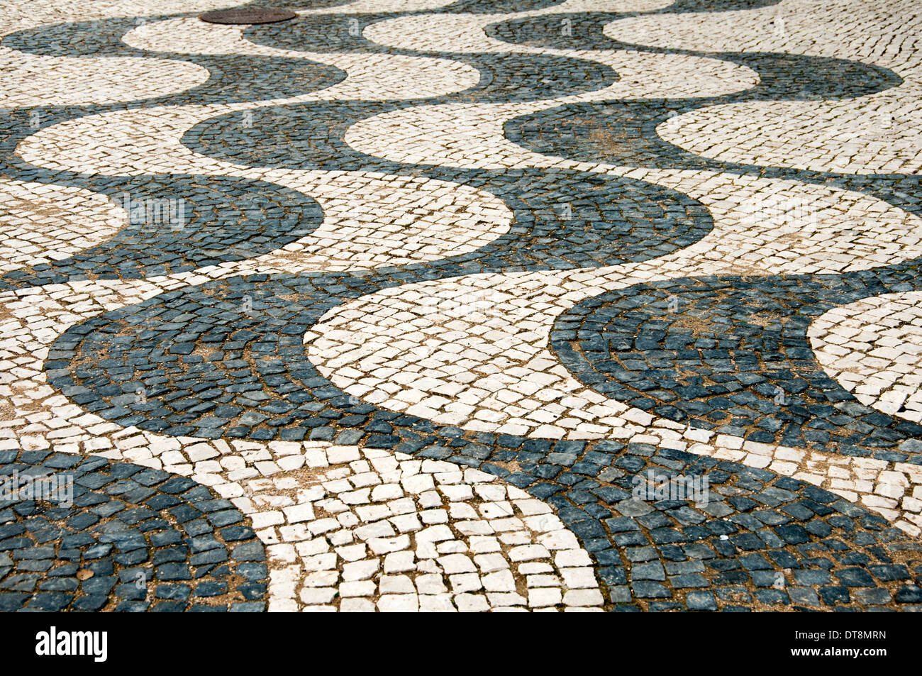 wavy line mosaic cobblestone street in Luz Portugal Stock Photo