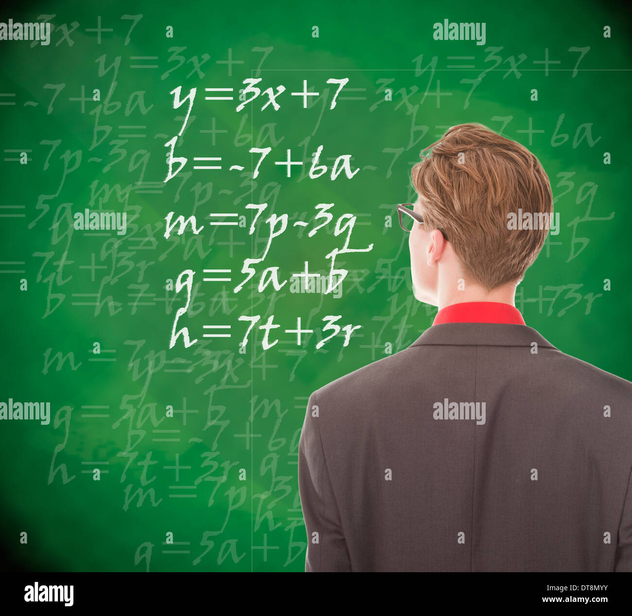 Young student looking at chalkboard with mathematics Stock Photo