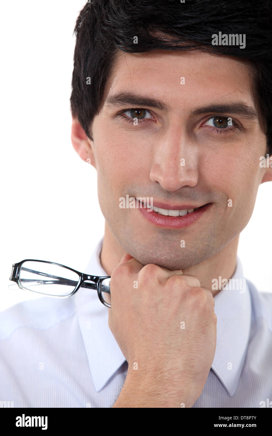 Smiling man holding his glasses Stock Photo