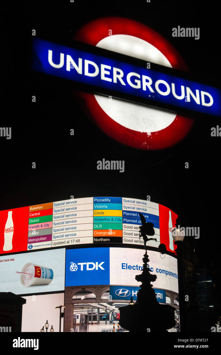 Electronic billboards at Piccadilly Circus warn how strike action is affecting London's Underground during evening rush hour Stock Photo