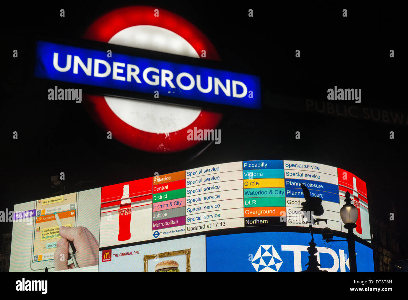 Electronic billboards at Piccadilly Circus warn how strike action is affecting London's Underground during evening rush hour Stock Photo