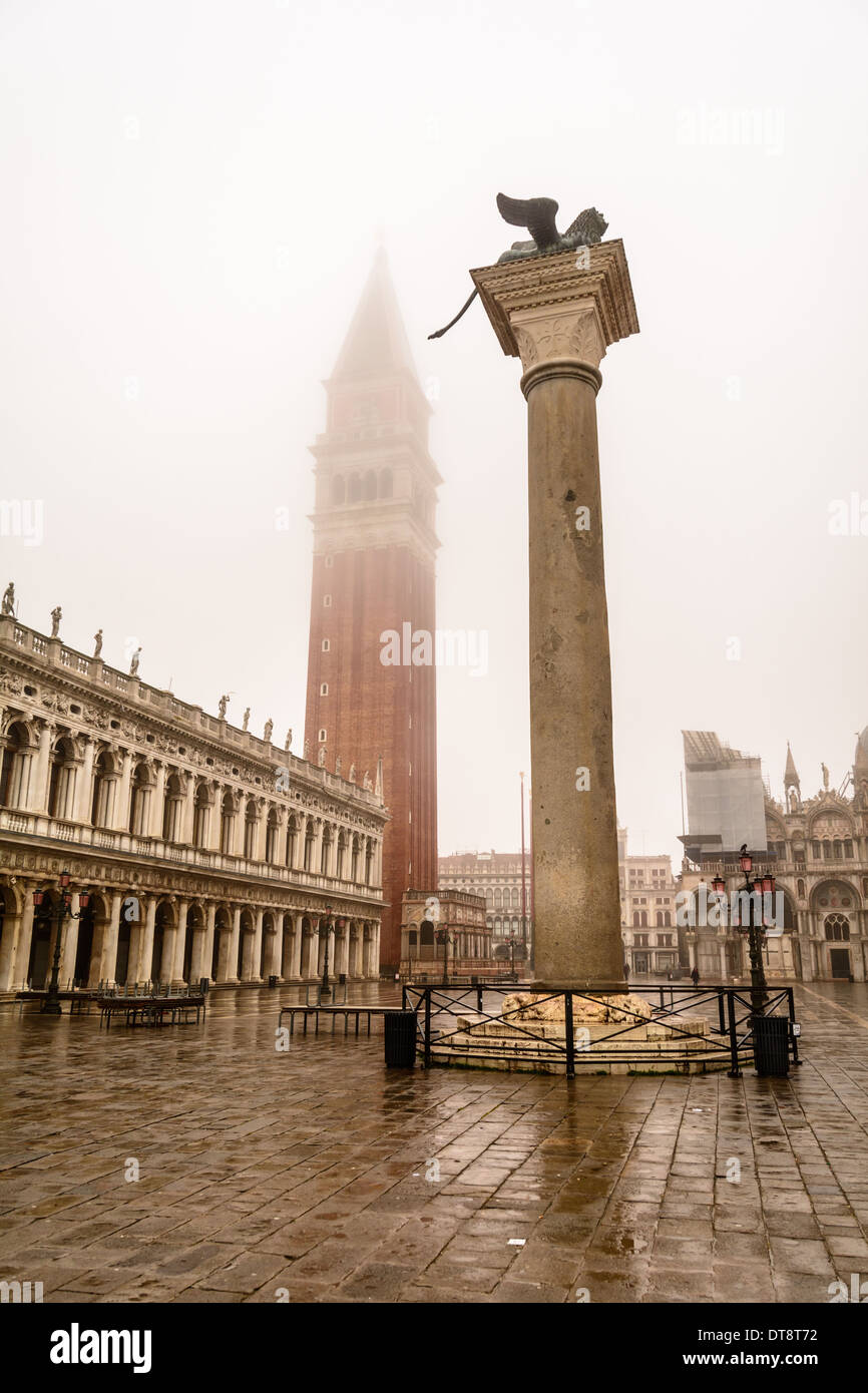 Venice, Italy. The Campanile, belltower, of St Mark´s square, covered in fog and the eastern column with the winged Lion of Venice, Piazzetta San Marco. Stock Photo