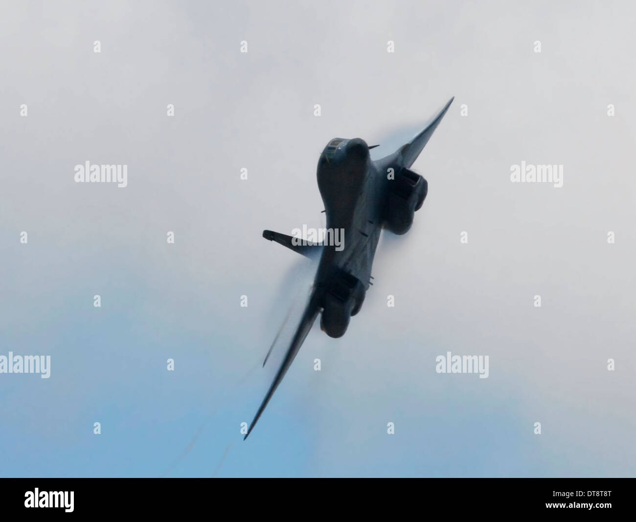 Rockwell B1 Bomber on very fast fly-by with water vapor shock wave on wings. Stock Photo
