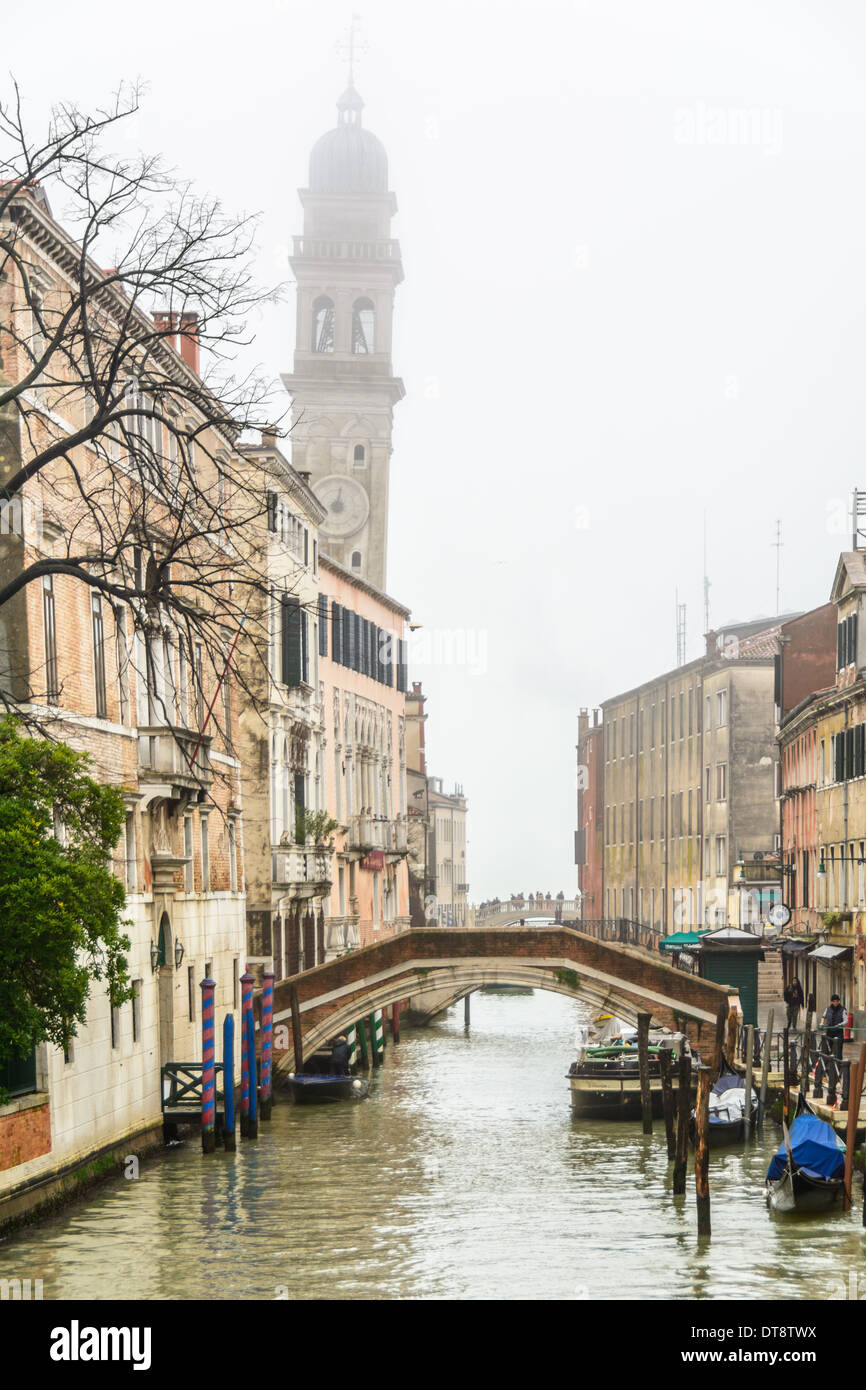 Venice, Italy. Canal, bridge, and the leaning belltower (campanile) of San Giorgio dei Greci, Saint George of the Greeks, a Greek Orthodox church, in the sestiere Castello, Venice. Stock Photo