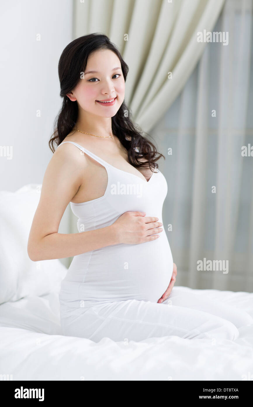 Pregnant woman holding her belly Stock Photo - Alamy