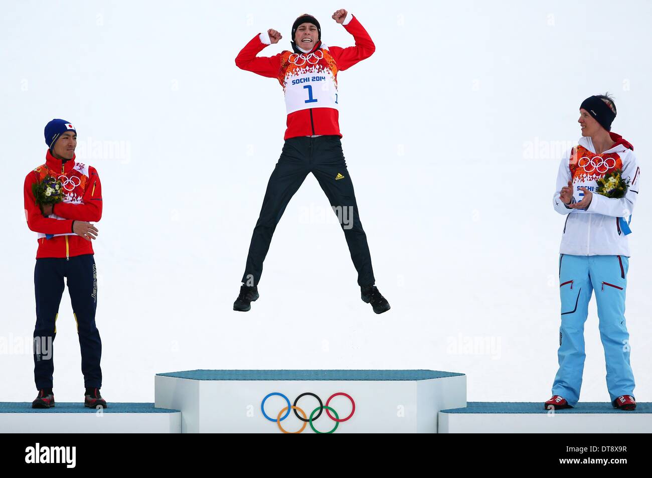 Sochi, Russia. 12th February 2014. Gold medalist Eric Frenzel (C) of Germany, silver medalist Akito Watabe (L) of Japan and bronze medalist Magnus Krog of Norway celebrate during the flower ceremony of the Nordic Combined Individual event (Individual Gundersen NH / 10 km, Cross-Country) in RusSki Gorki Center at the Sochi 2014 Olympic Games, Krasnaya Polyana, Russia, 12 February 2014. Photo: Daniel Karmann/dpa Credit:  dpa picture alliance/Alamy Live News Stock Photo