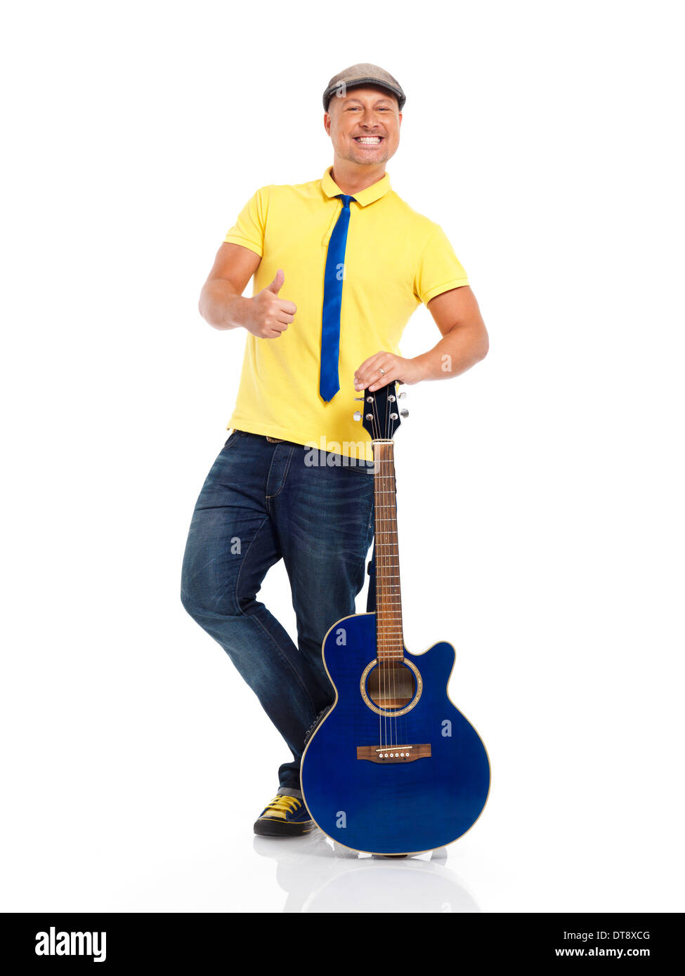 Portrait of a happy smiling young man guitar player standing with an acoustic guitar isolated on white background Stock Photo